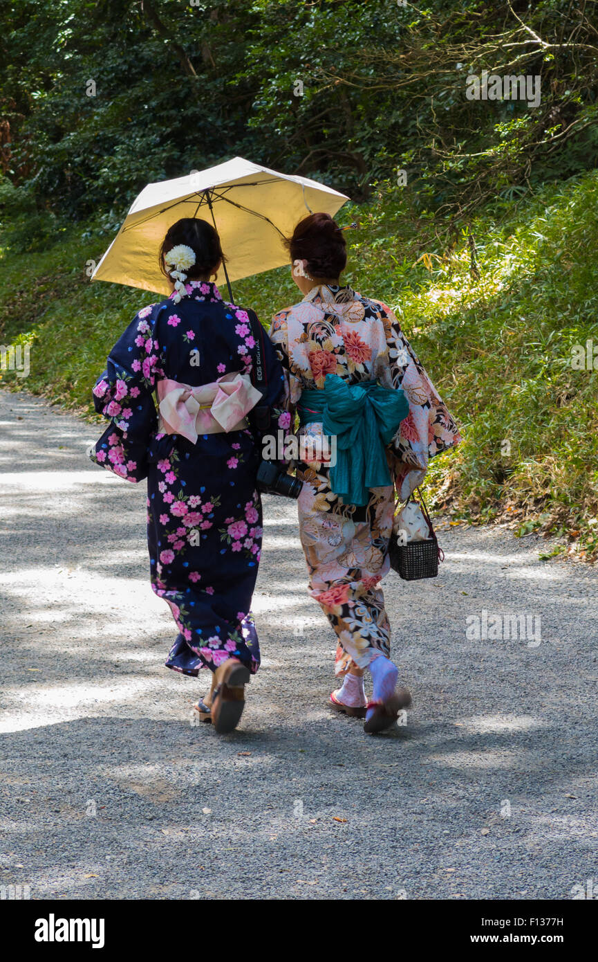 Two japanese girls with parasol dressed in Kimono Stock Photo