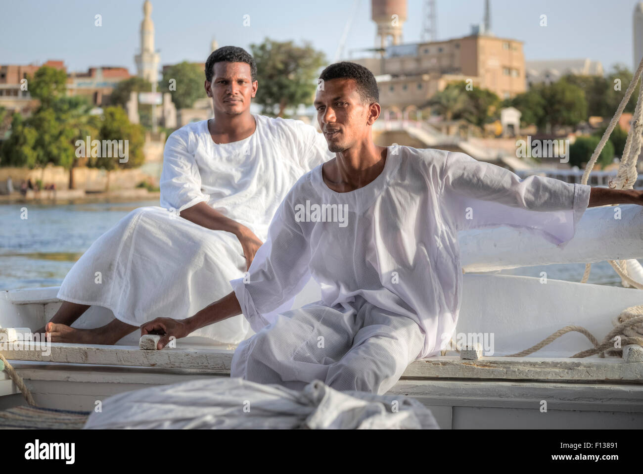 Egyptian sailing men, sailing a traditional felucca in Aswan, Egypt, Africa Stock Photo