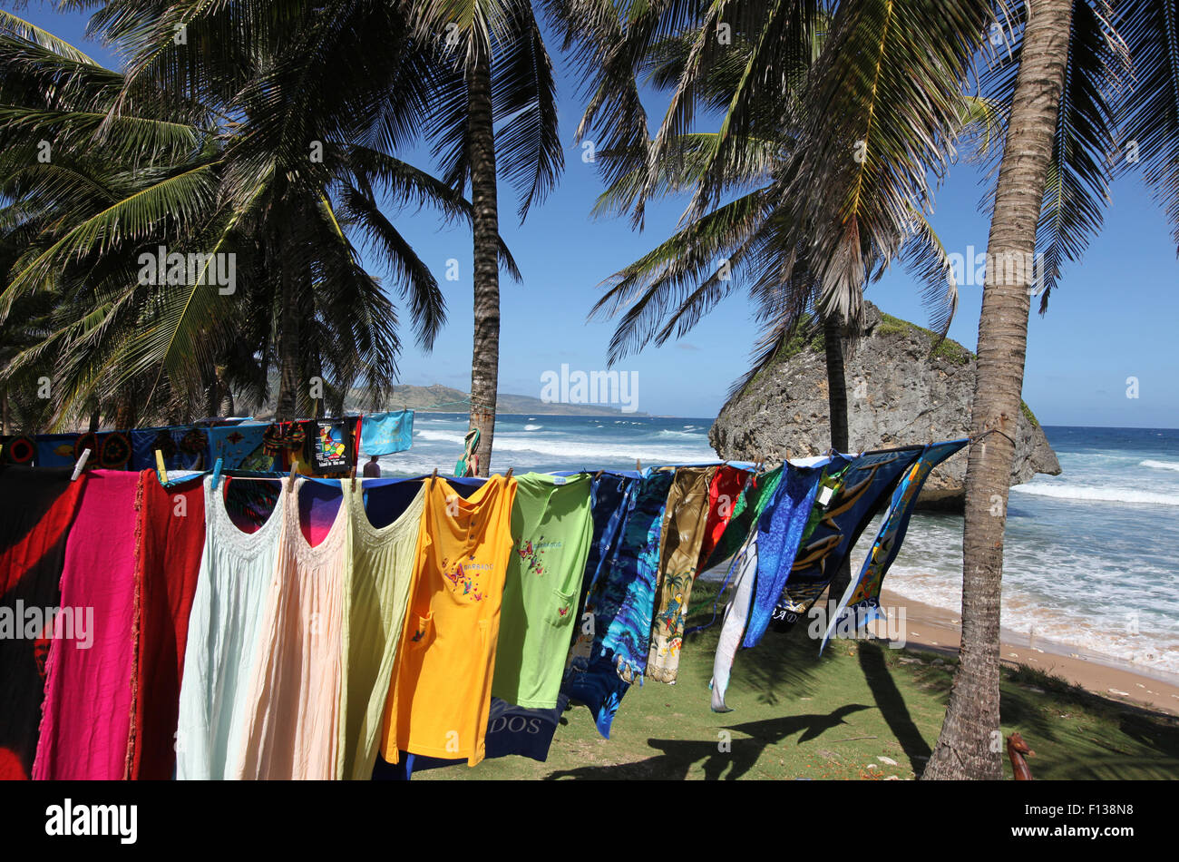 Bright coloured clothes hanging on a line at Bathsheba beach in Barbados in the Caribbean Stock Photo