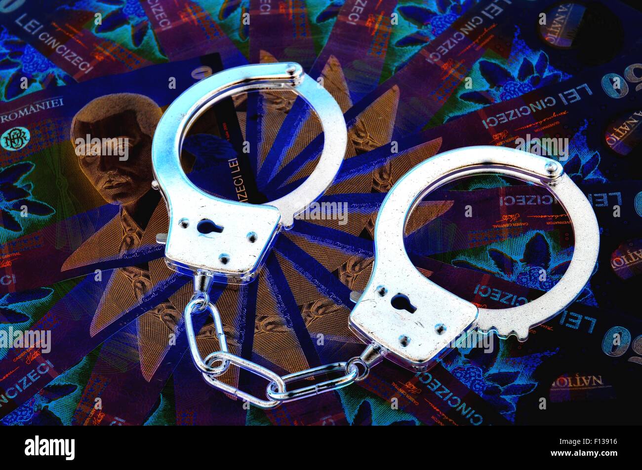 Romanian currency (lei) and handcuffs Stock Photo