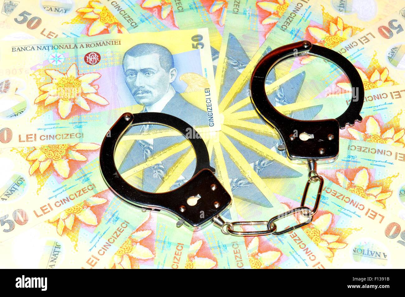 Romanian currency (lei) and handcuffs Stock Photo