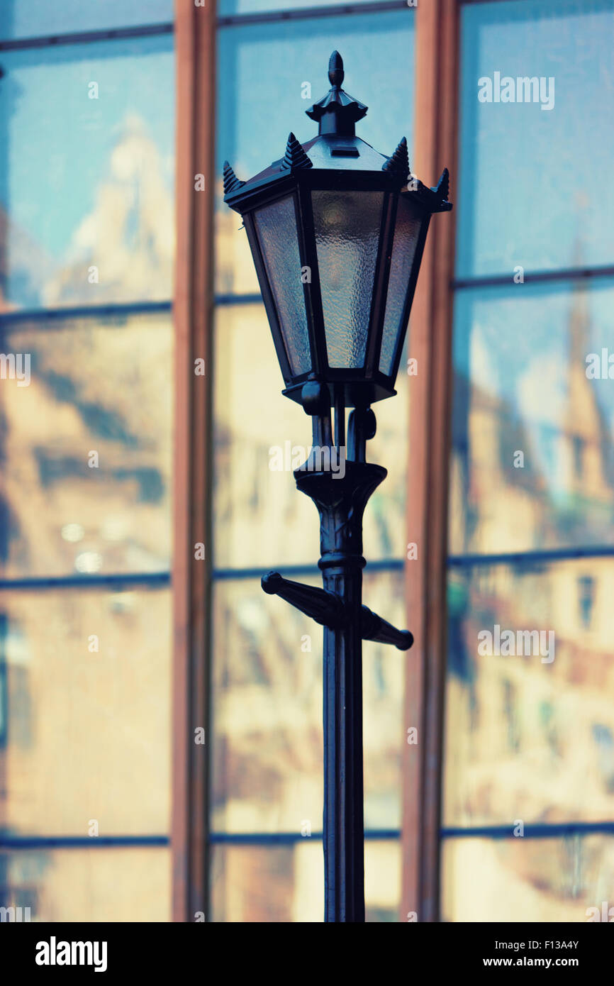Latvia, Riga. Street lamp on the background of the reflection in the glass windows of old houses of the old town Stock Photo