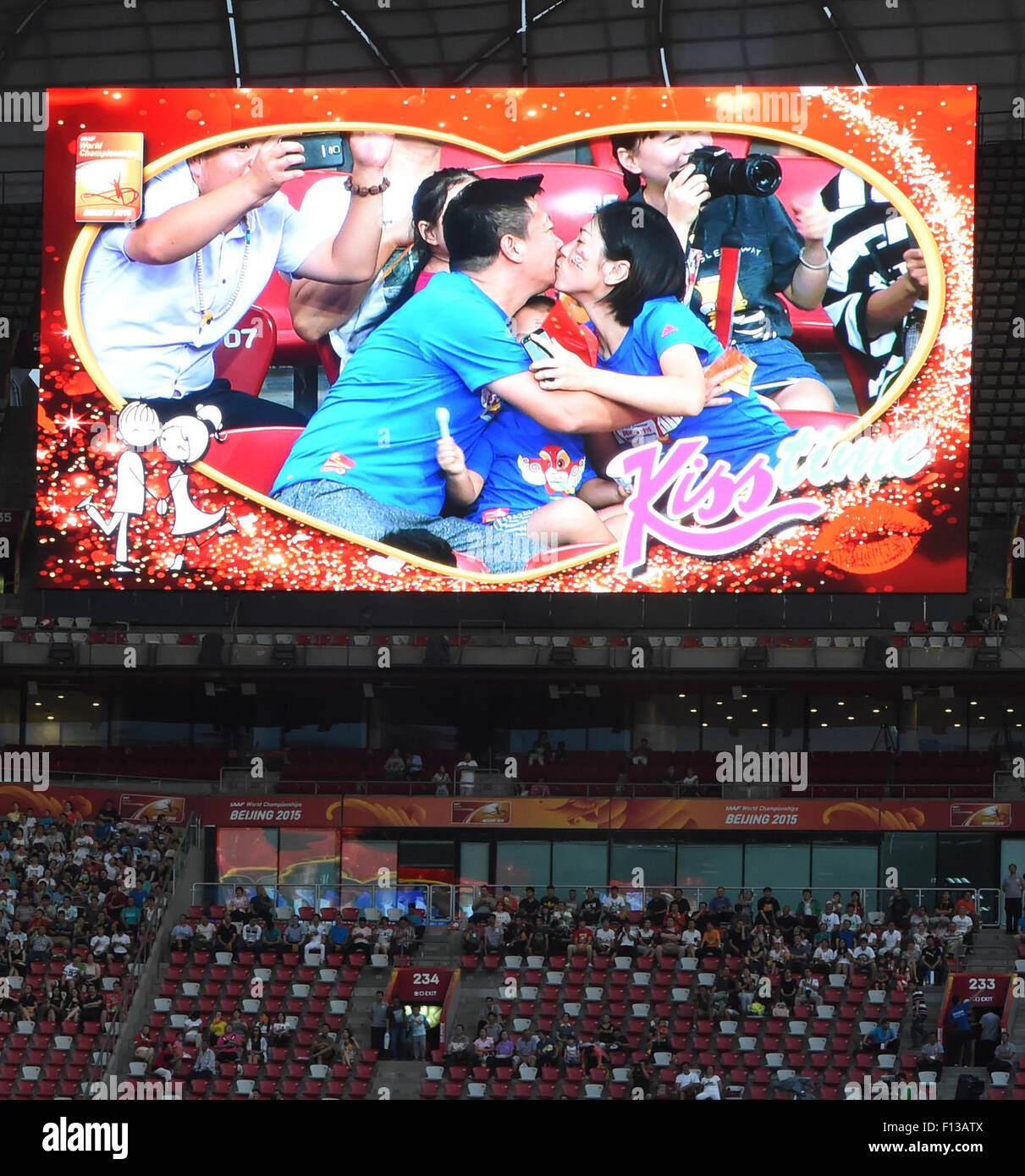 Beijing, China. 26th Aug, 2015. The screen in the stadium shows two parents kiss each other before the afternoon match of Day 5 at the 2015 IAAF World Championships at the 'Bird's Nest' National Stadium in Beijing, capital of China, Aug. 26, 2015. © Wang Haofei/Xinhua/Alamy Live News Stock Photo