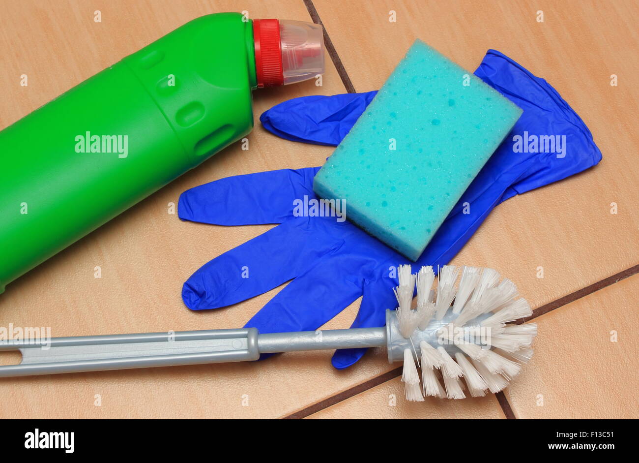 Accessories for cleaning bathroom on ceramics flooring, brush, glove, sponge, concept for house