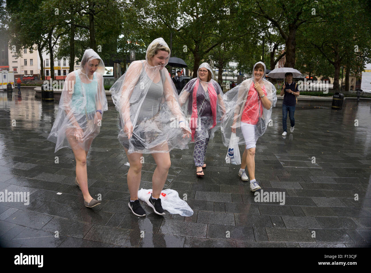 London, UK. Sunday 23rd August 2015. Heavy summer rain showers in the