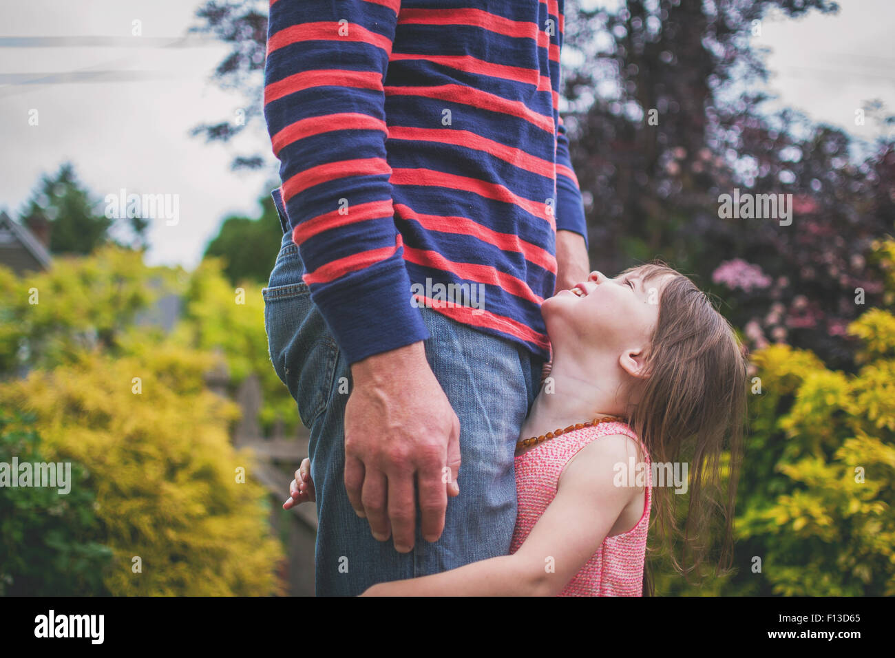 Baby with fathers long legs Stock Photo - Alamy