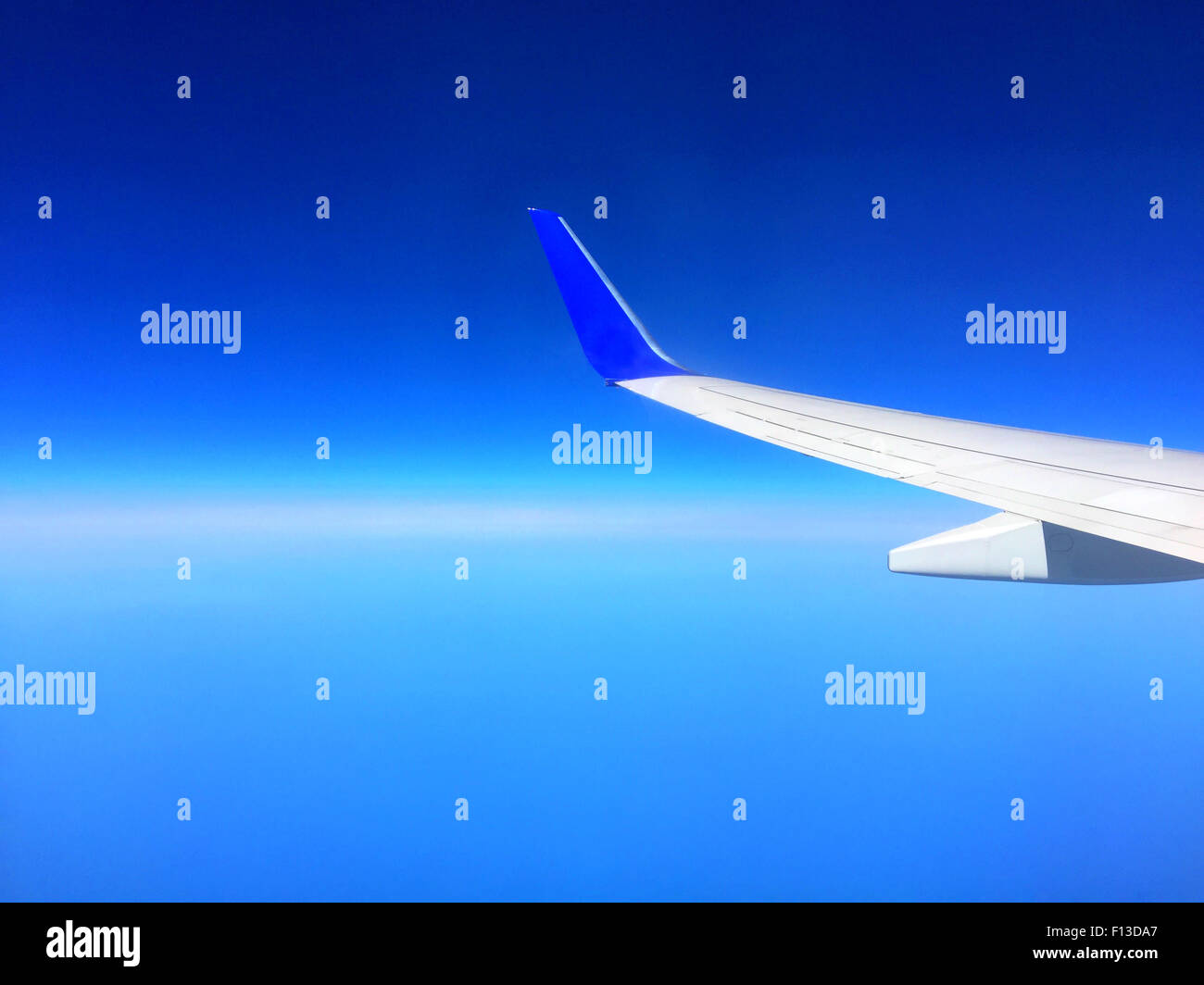 Airplane wing and blue sky Stock Photo - Alamy