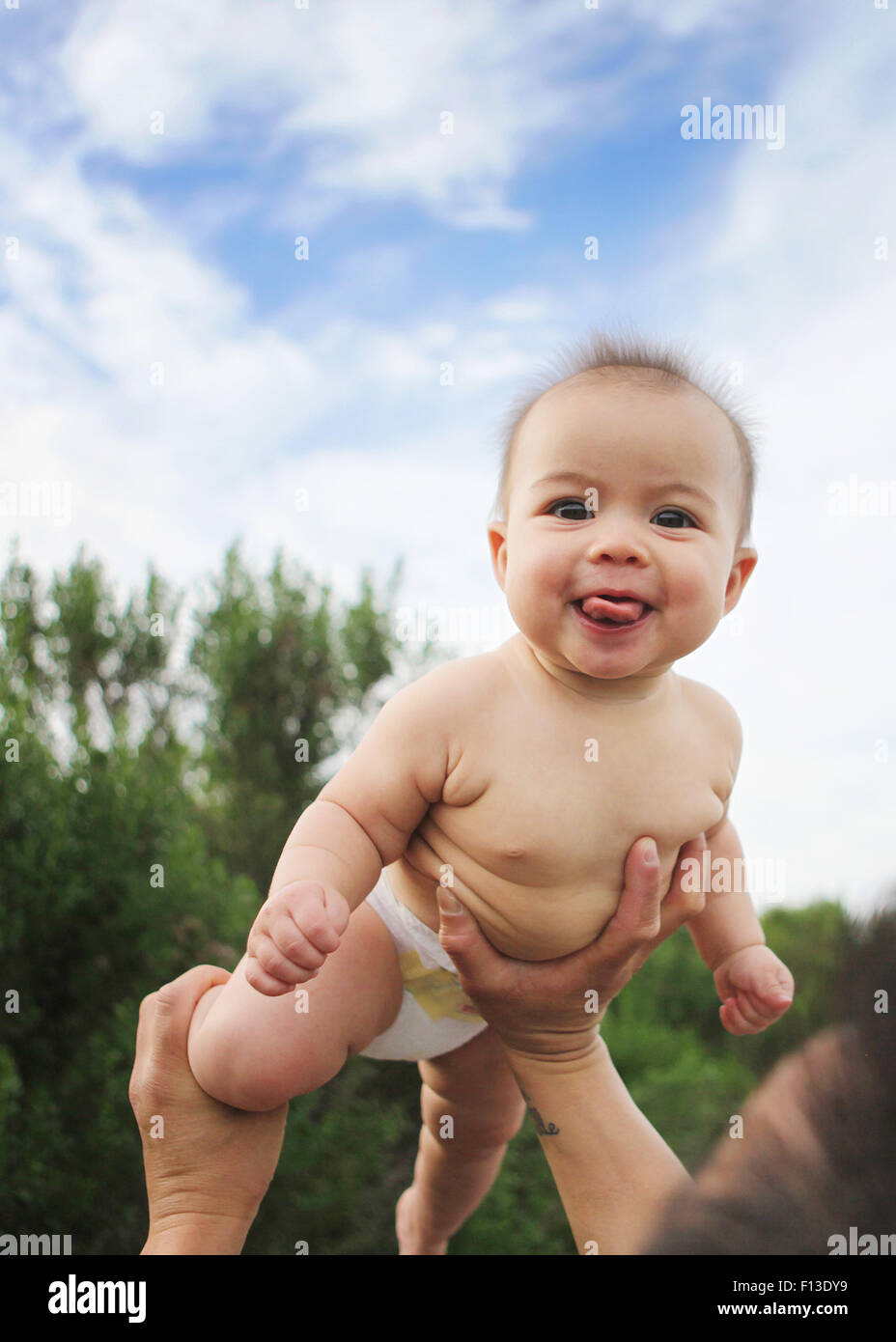 Father lifting baby girl in the air Stock Photo