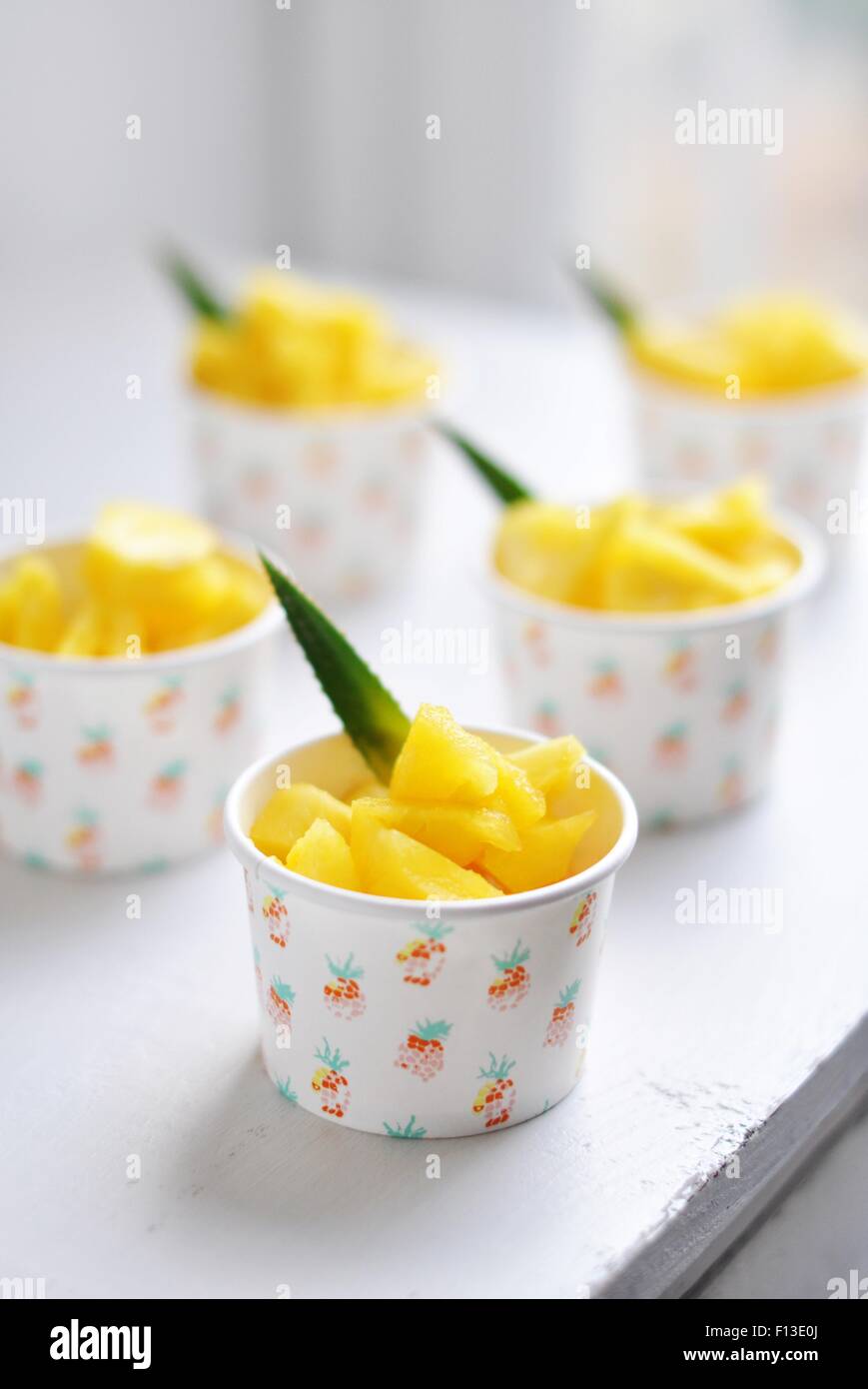 Five paper cups filled with pineapple chunks Stock Photo Alamy