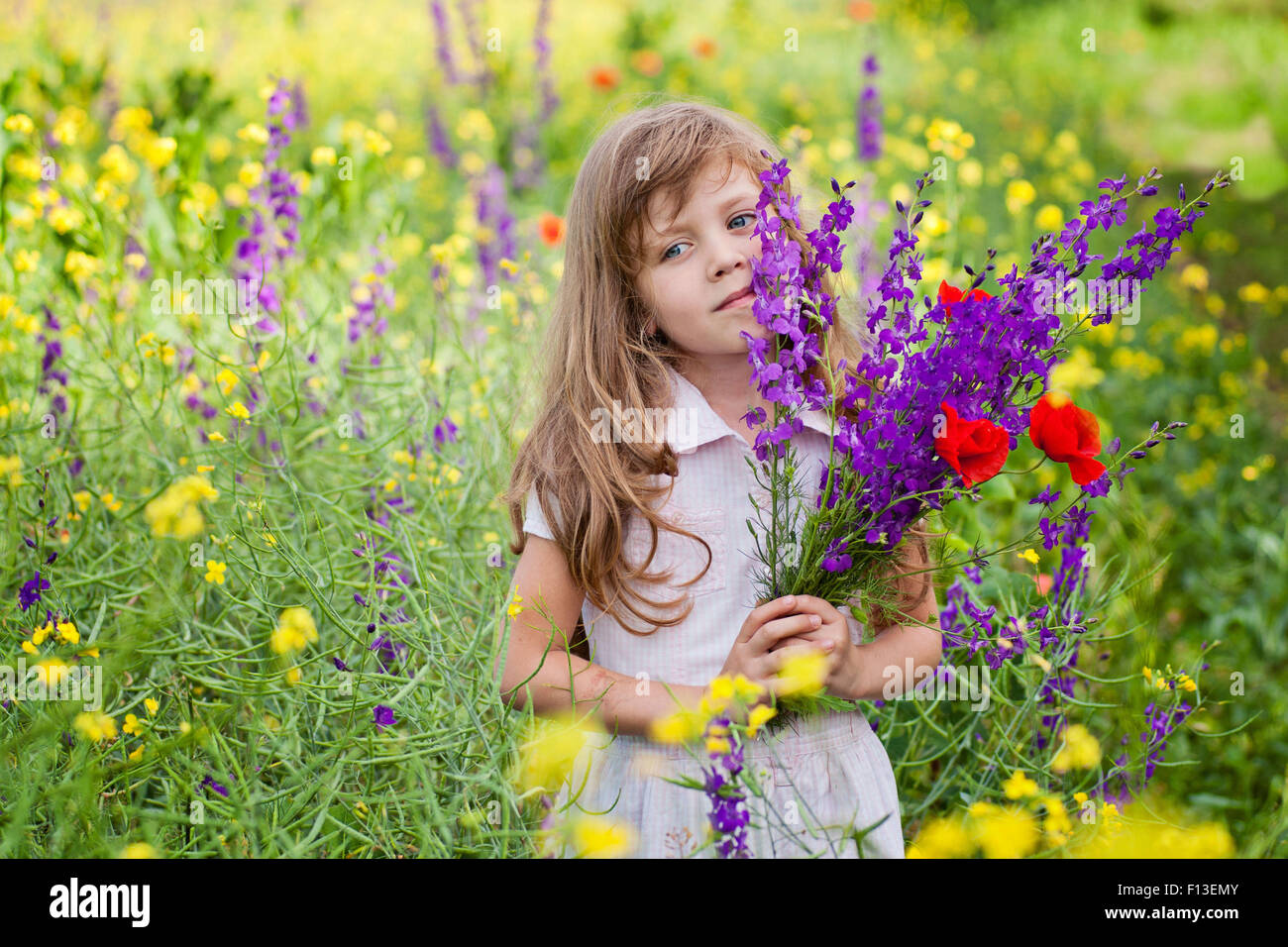 Portrait of a girl holding a bunch of flowers Stock Photo - Alamy
