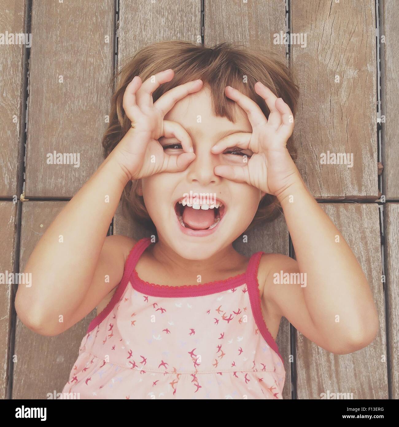 Girl looking through finger frames Stock Photo