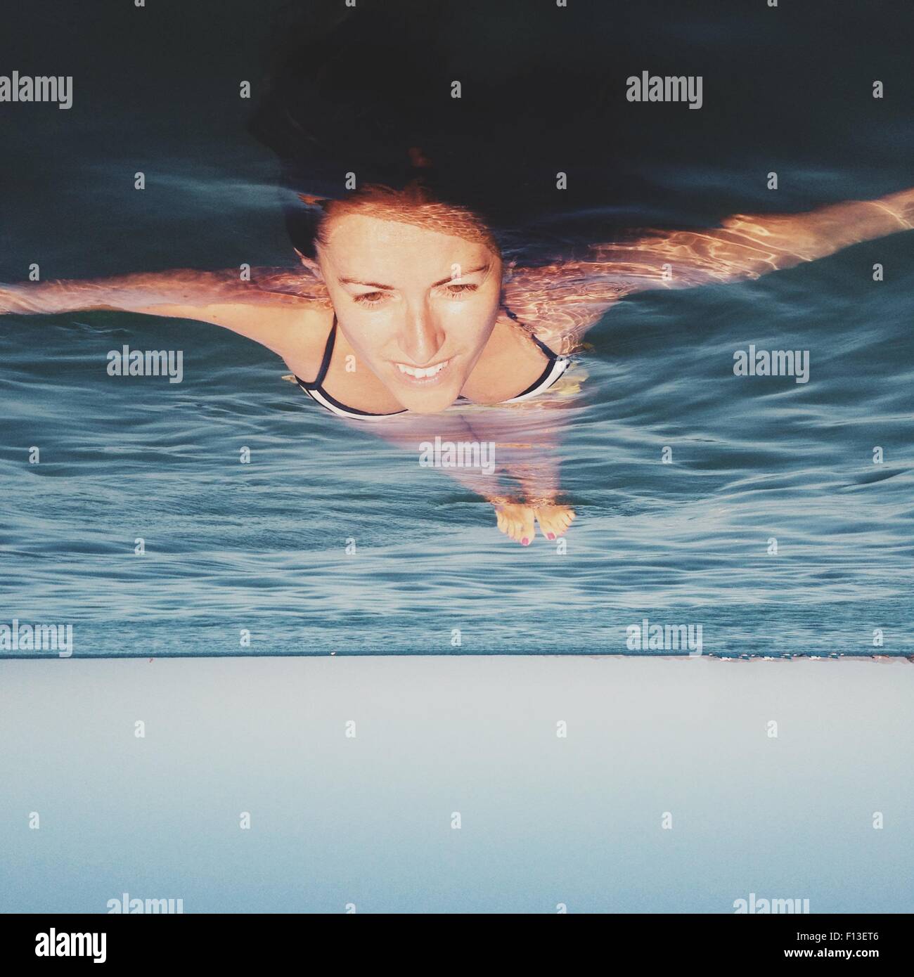 Woman floating in the sea Stock Photo