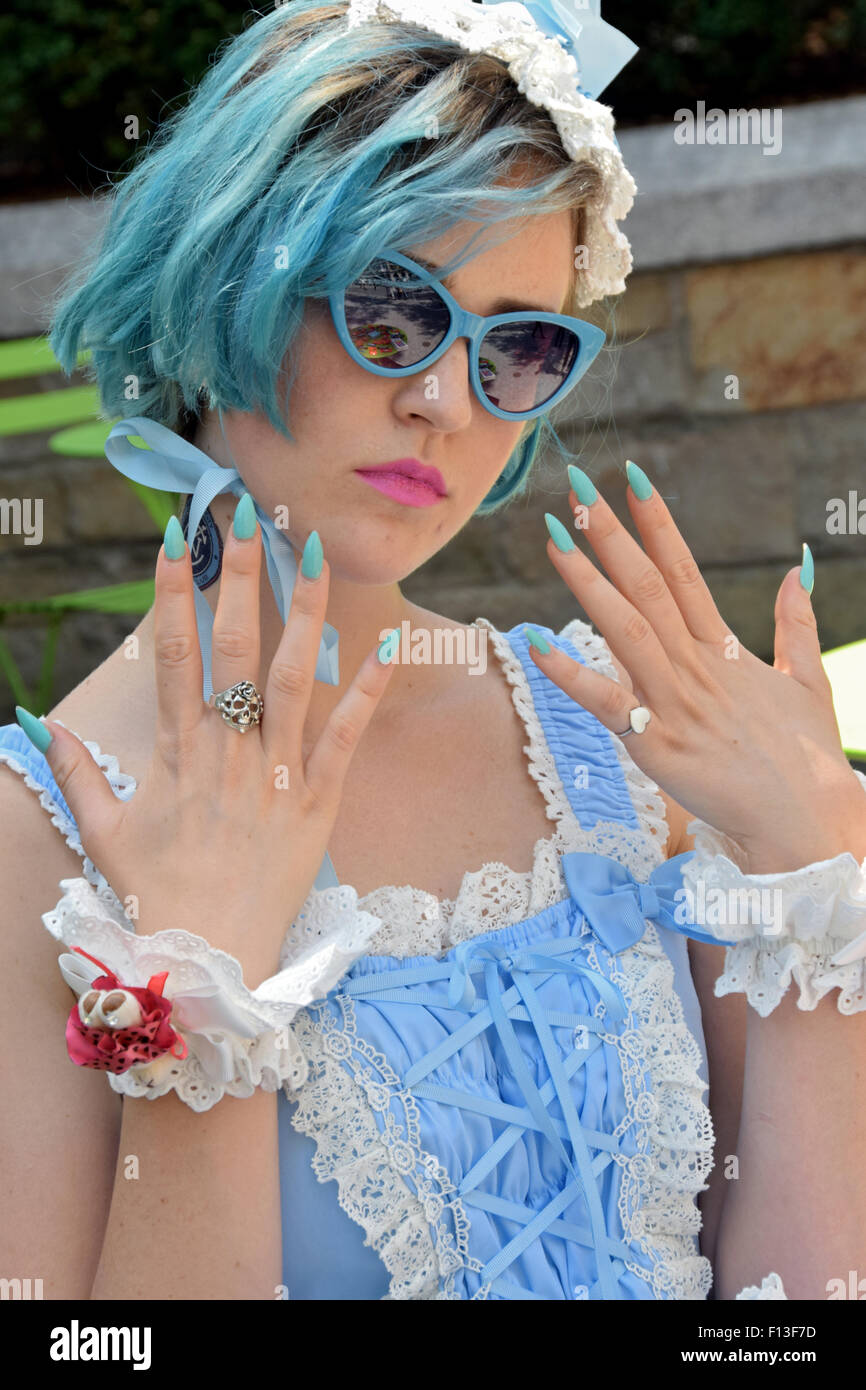 A performance artist dressed in light blue with light blue hair at Union Square Park in New York City Stock Photo
