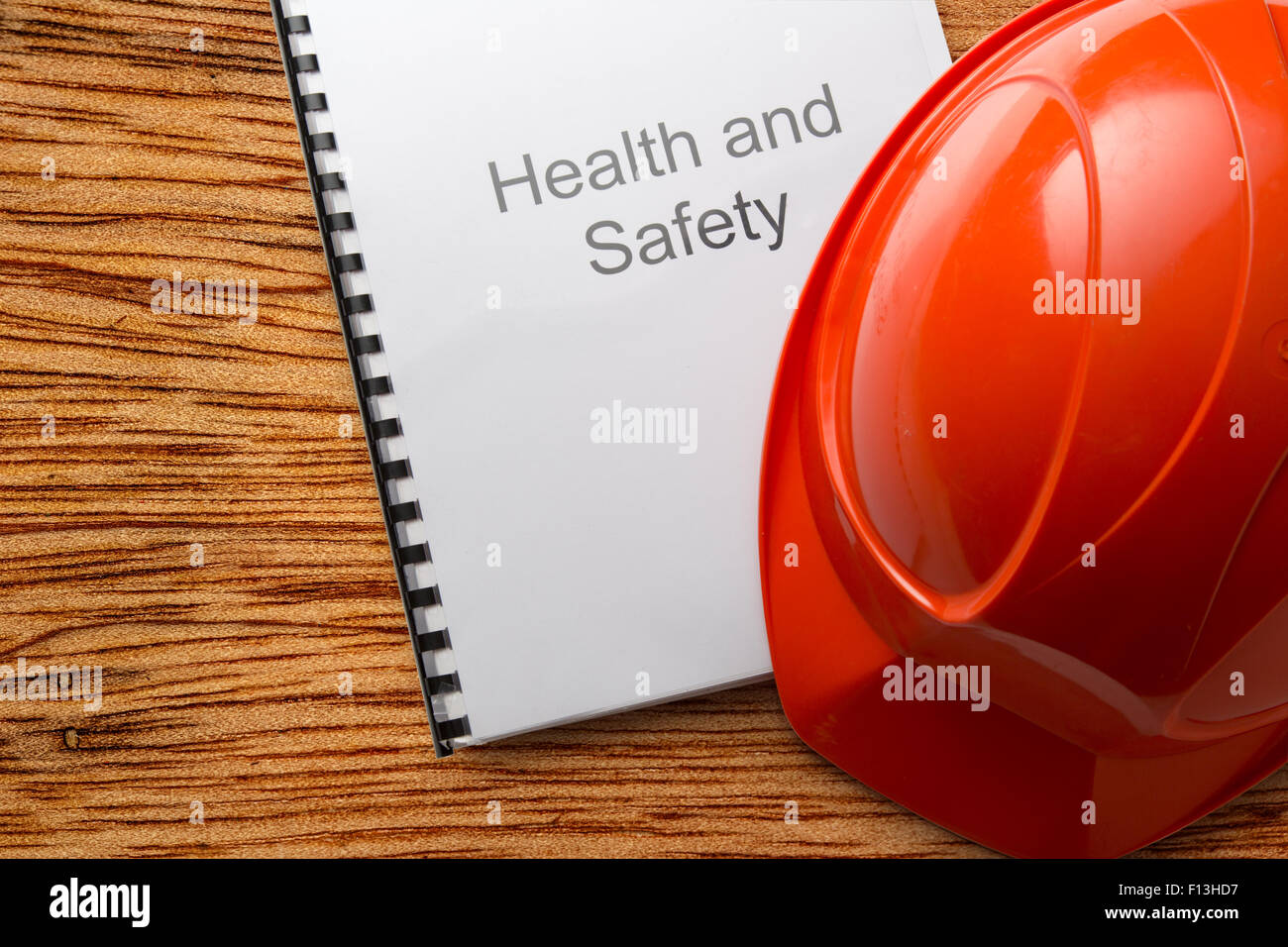 Health and safety register with helmet in closeup Stock Photo