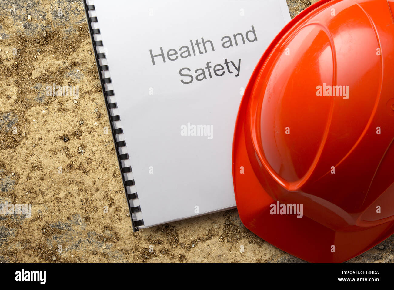 Health and safety register with helmet in closeup Stock Photo