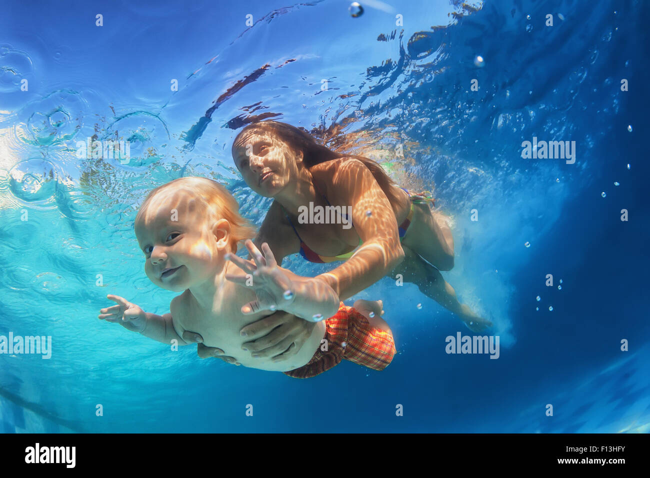 Family lifestyle. Holiday with children. Little funny baby swimming