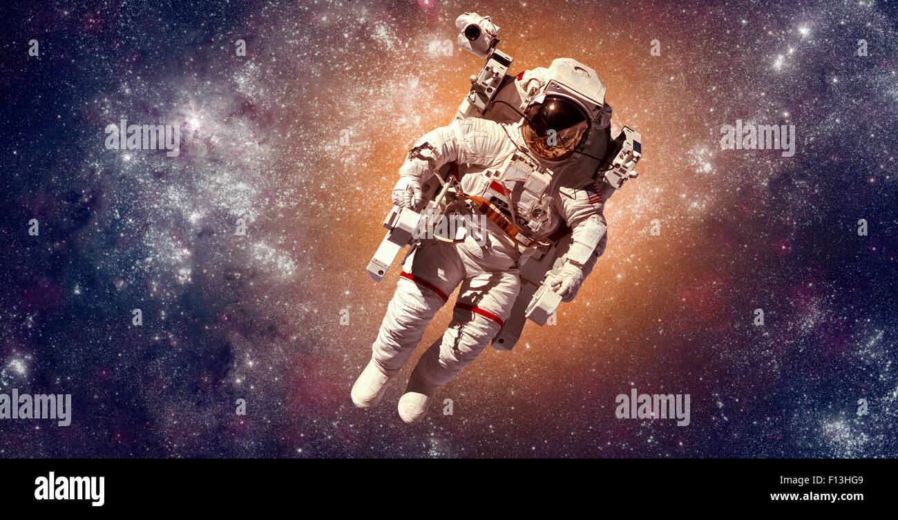 Astronaut in outer space against the backdrop of the planet earth. Elements of this image furnished by NASA. Stock Photo