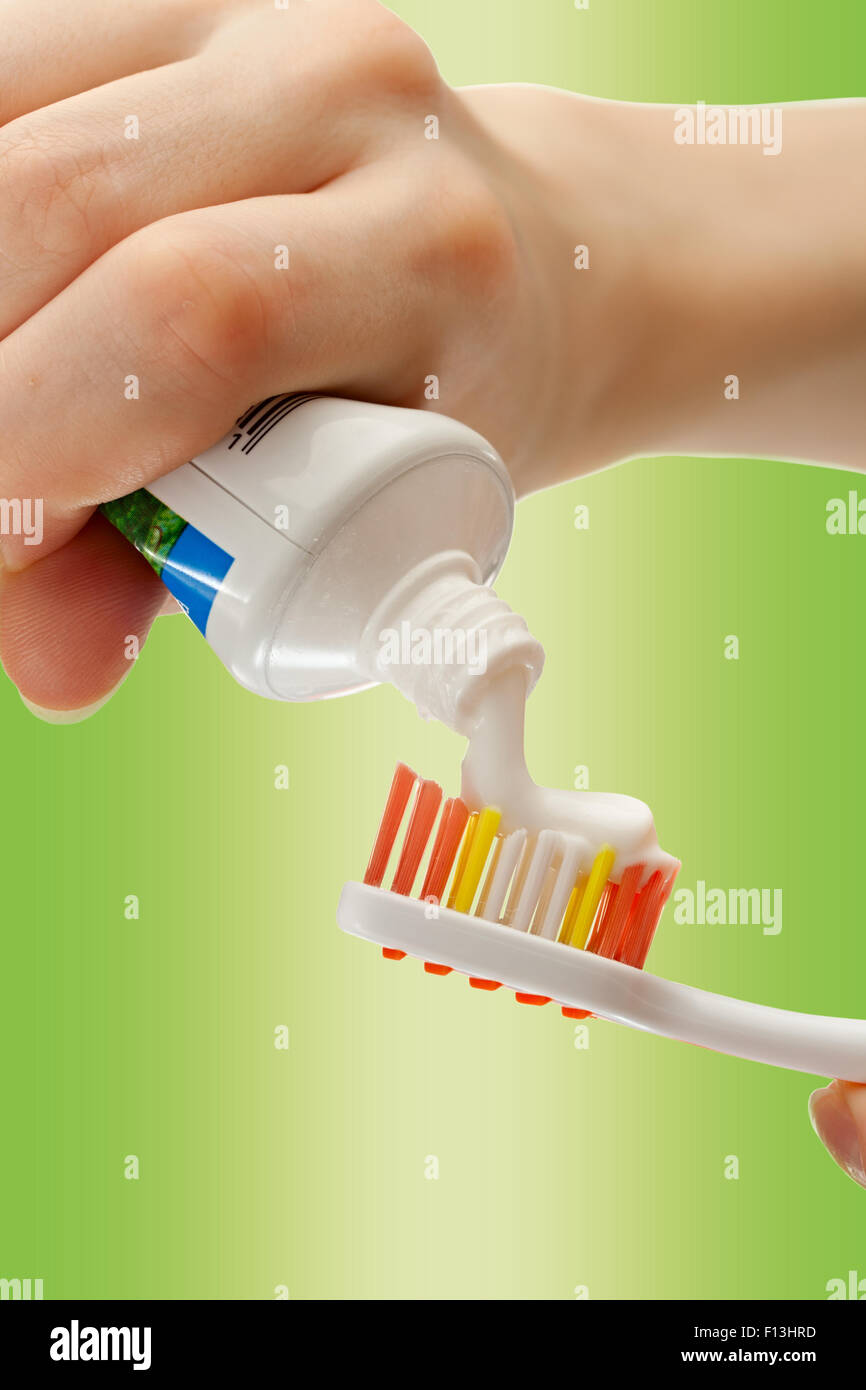 Toothbrush and toothpaste in female hands in closeup Stock Photo Alamy