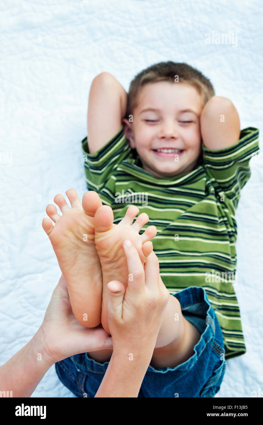 boy laughing foot tickled Stock Photo