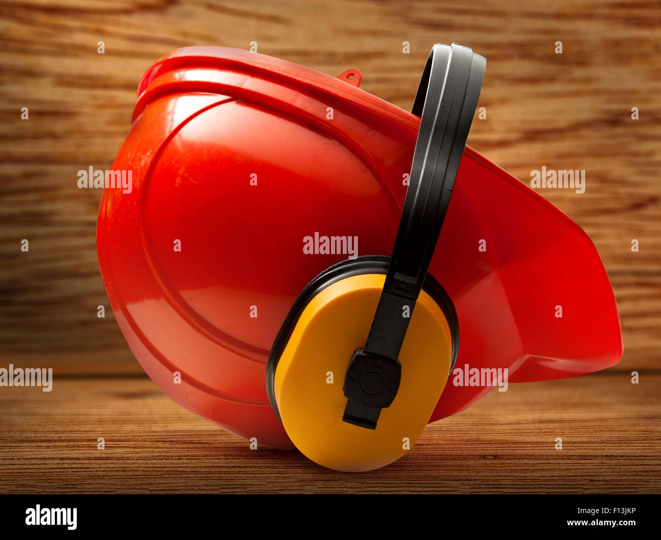 Red safety helmet with earphones in closeup Stock Photo Alamy