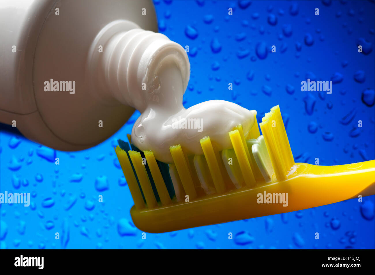 Toothbrush and toothpaste on blue water background Stock Photo - Alamy