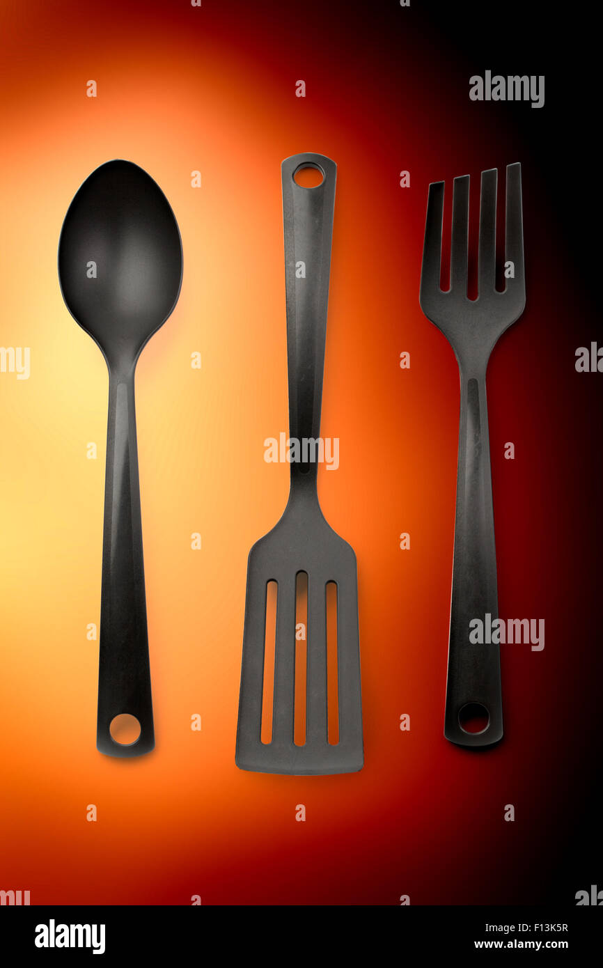 Kitchen utensil collection set of three on orange Stock Photo