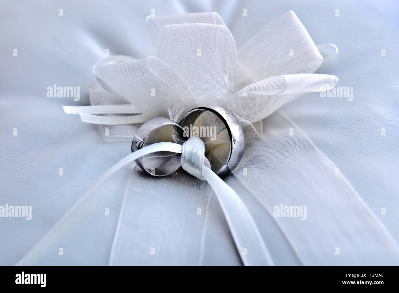 His and hers silver wedding rings neatly on display and ready for the