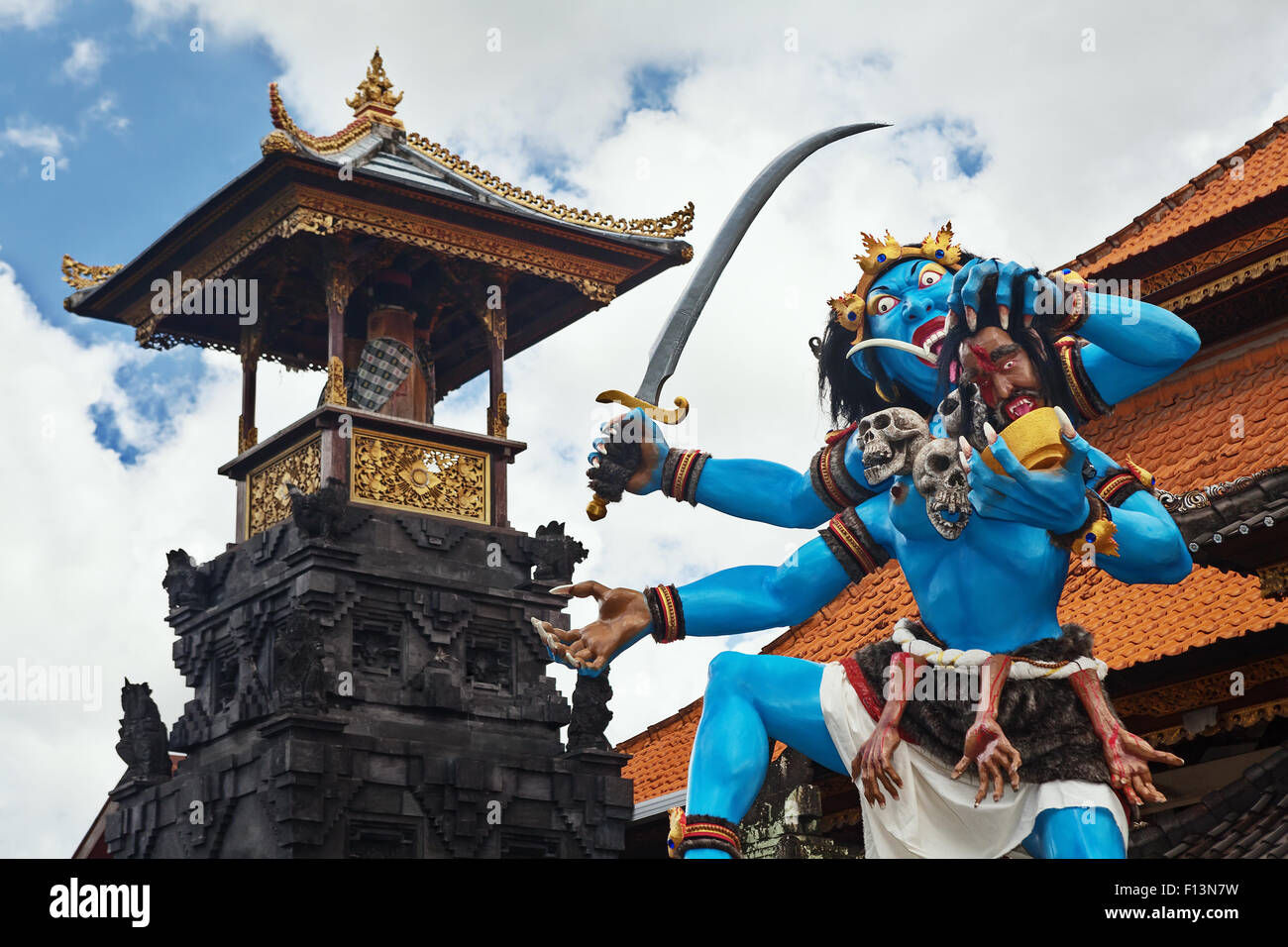 Blue coloured traditional demon ogoh-ogoh holding a severed head and decorated with skulls before the annual monster parade. Stock Photo