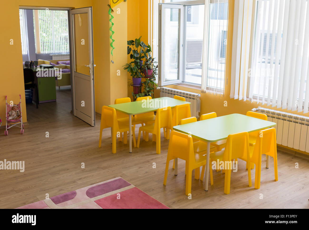 Kindergarten classroom with small chairs and tables for the kids Stock