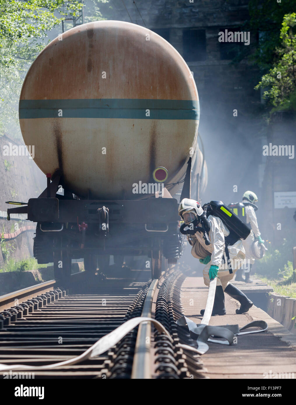 A team working with toxic acids and chemicals is approaching a chemical cargo train crash near Sofia, Bulgaria. Teams from Fire  Stock Photo