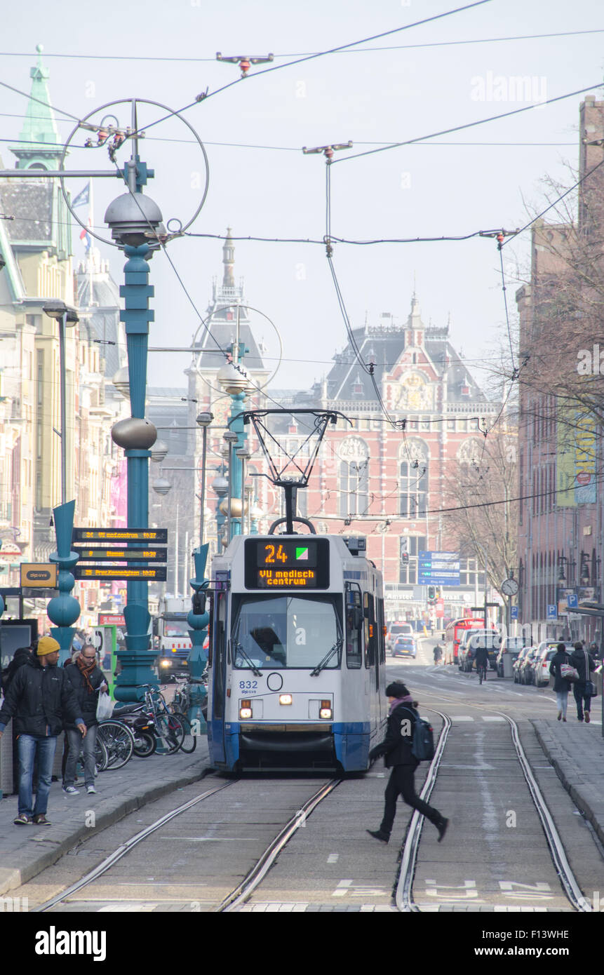 The Tram In Amsterdam Passing By One Of The Central Streets Stock Photo how-to-ride-the-tram-in-amsterdam