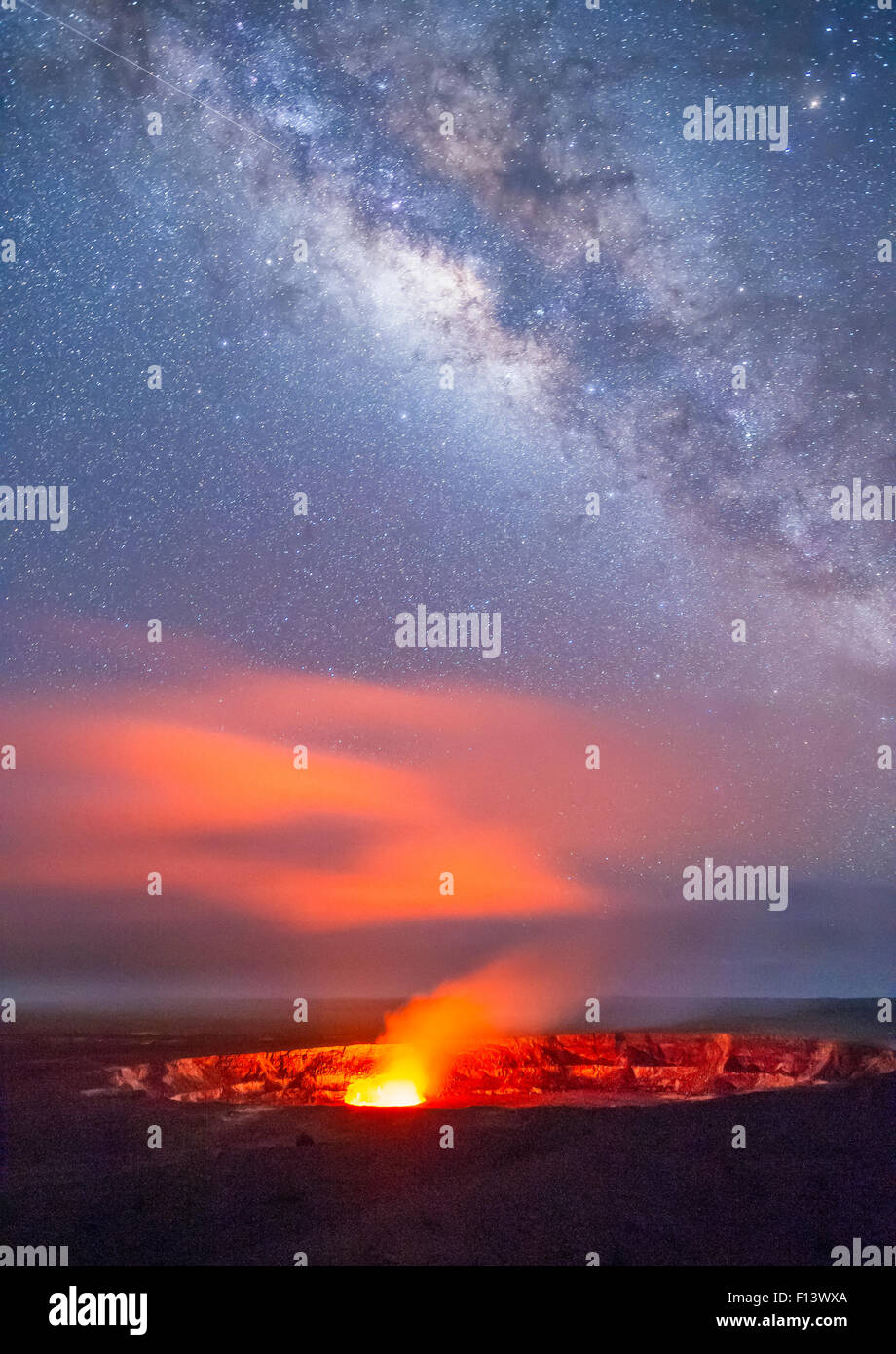 Glowing gases rising from Halemaumau Crater, Kilauea Caldera, in evening with Milky Way in the sky above.  Hawaii Volcanoes National Park, Hawaii, August 2010. Stock Photo