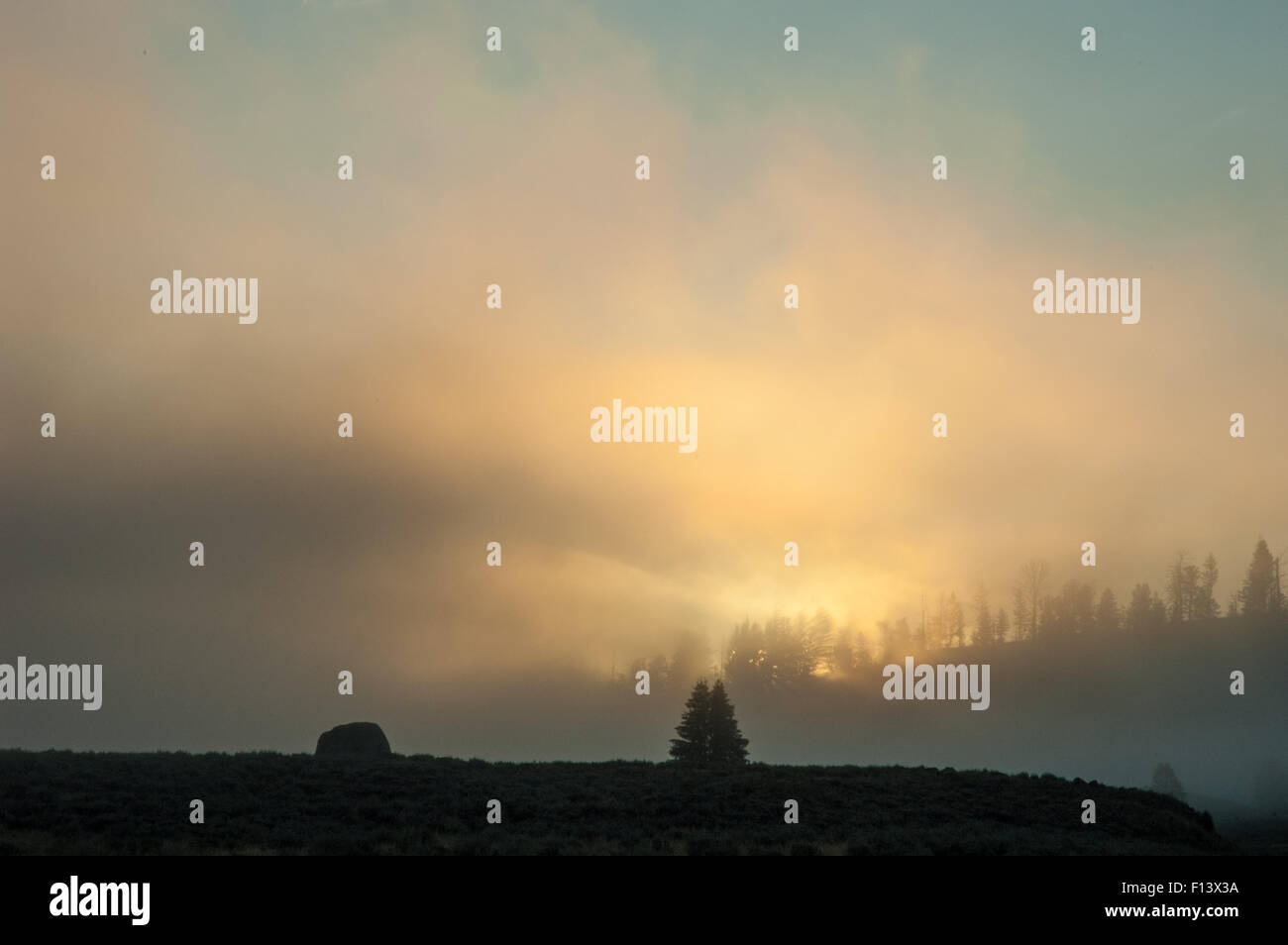 Sunrise with log clouds and fog Stock Photo - Alamy