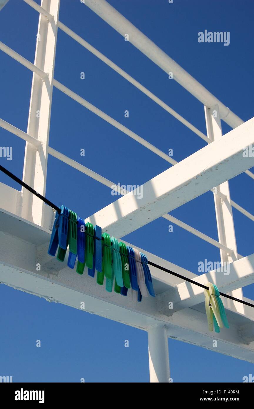 green and blue pegs on a line on a Greek ferry Stock Photo