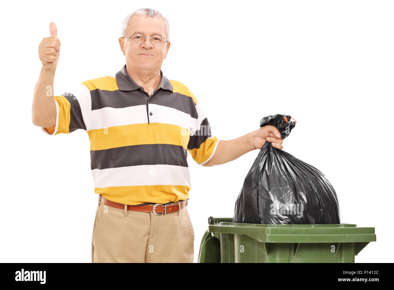 Senior giving a thumb up by a trash can isolated on white background ...