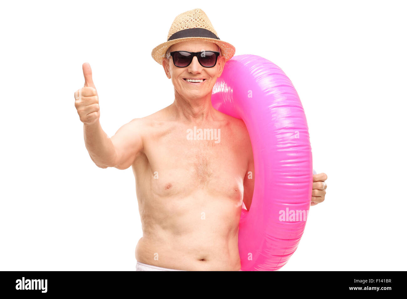Senior man carrying a big pink swimming ring and giving a thumb up isolated on white Stock Photo