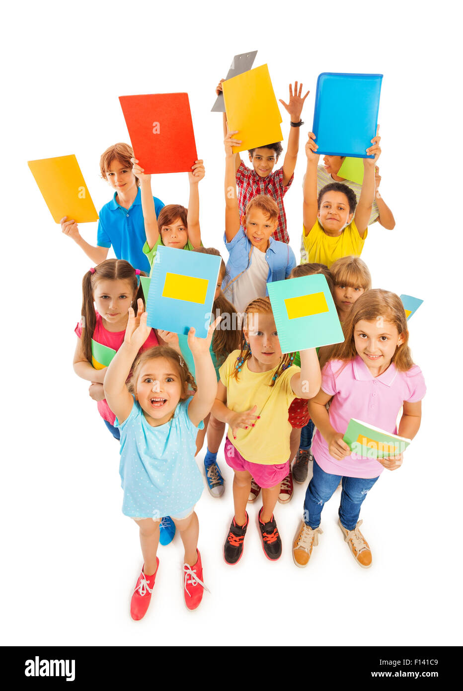 Eight years old kids lifting textbooks Stock Photo