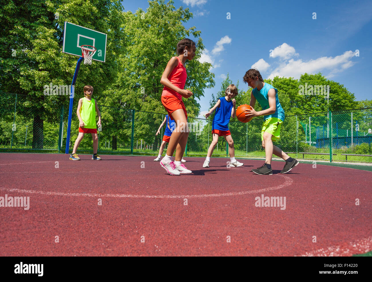 Boys and girl play basketball game on playground Stock Photo Alamy