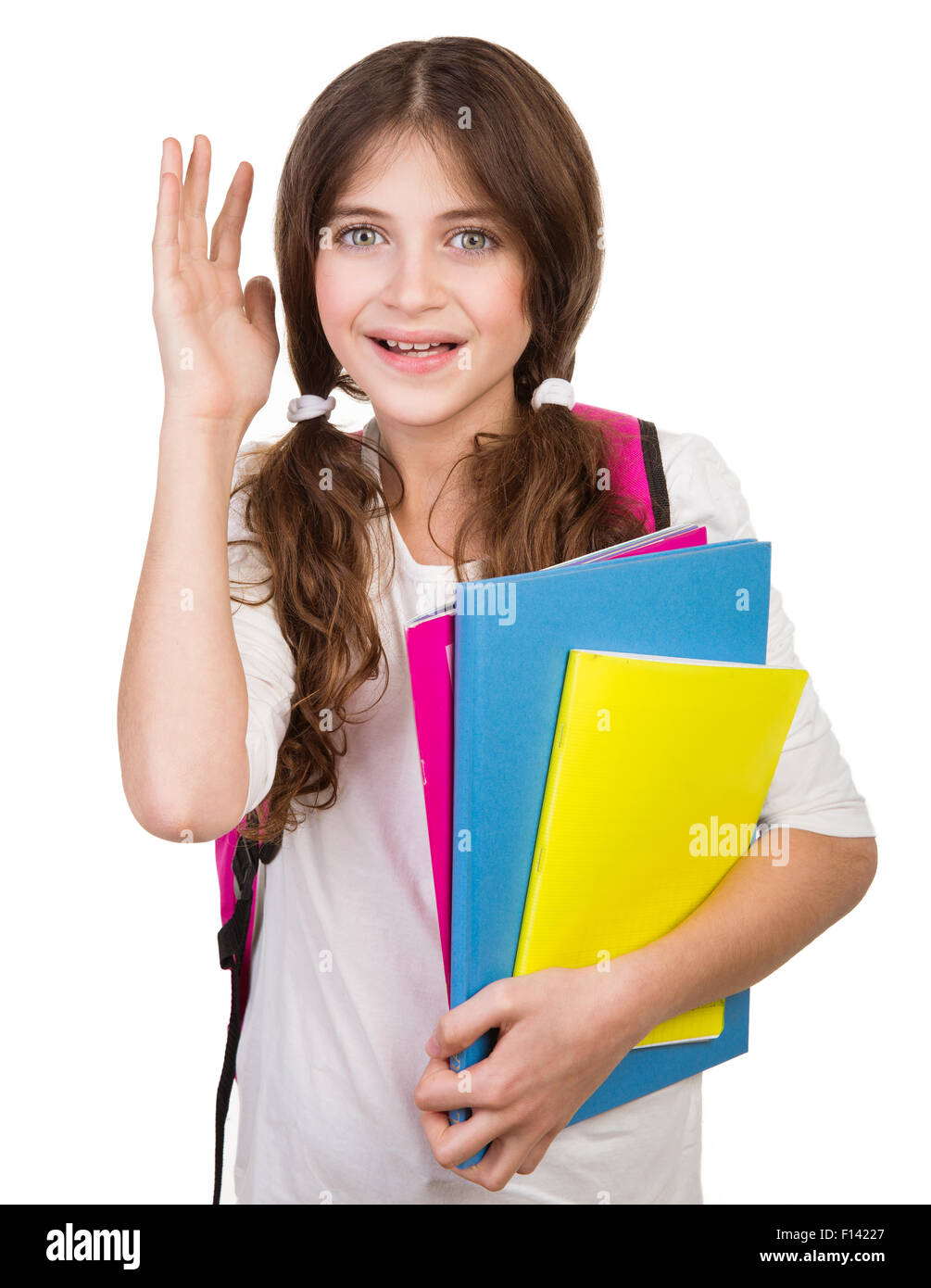 Portrait of cute schoolgirl with bag and books in hands isolated on ...