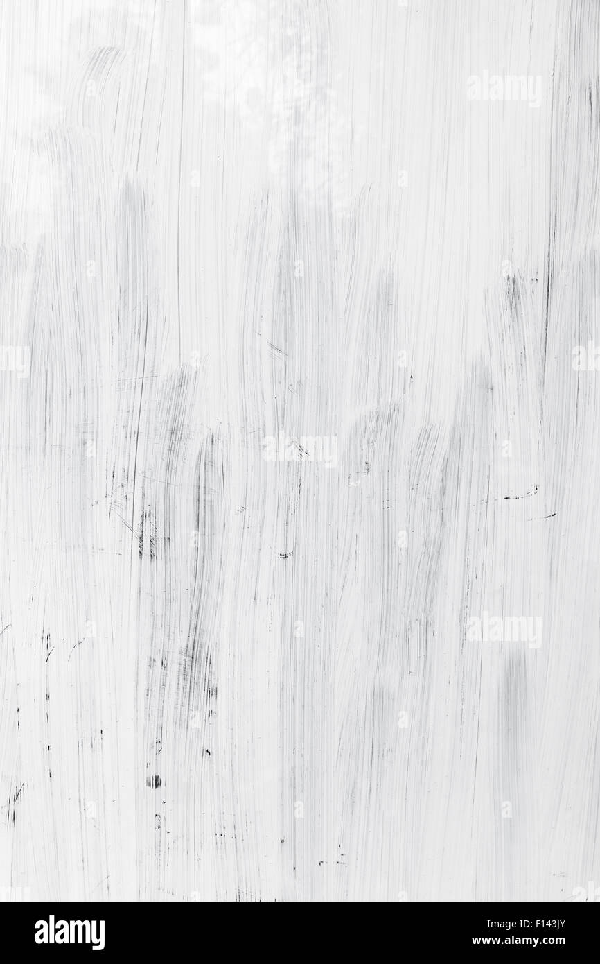 White paint layer over glass wall, vertical background texture Stock Photo