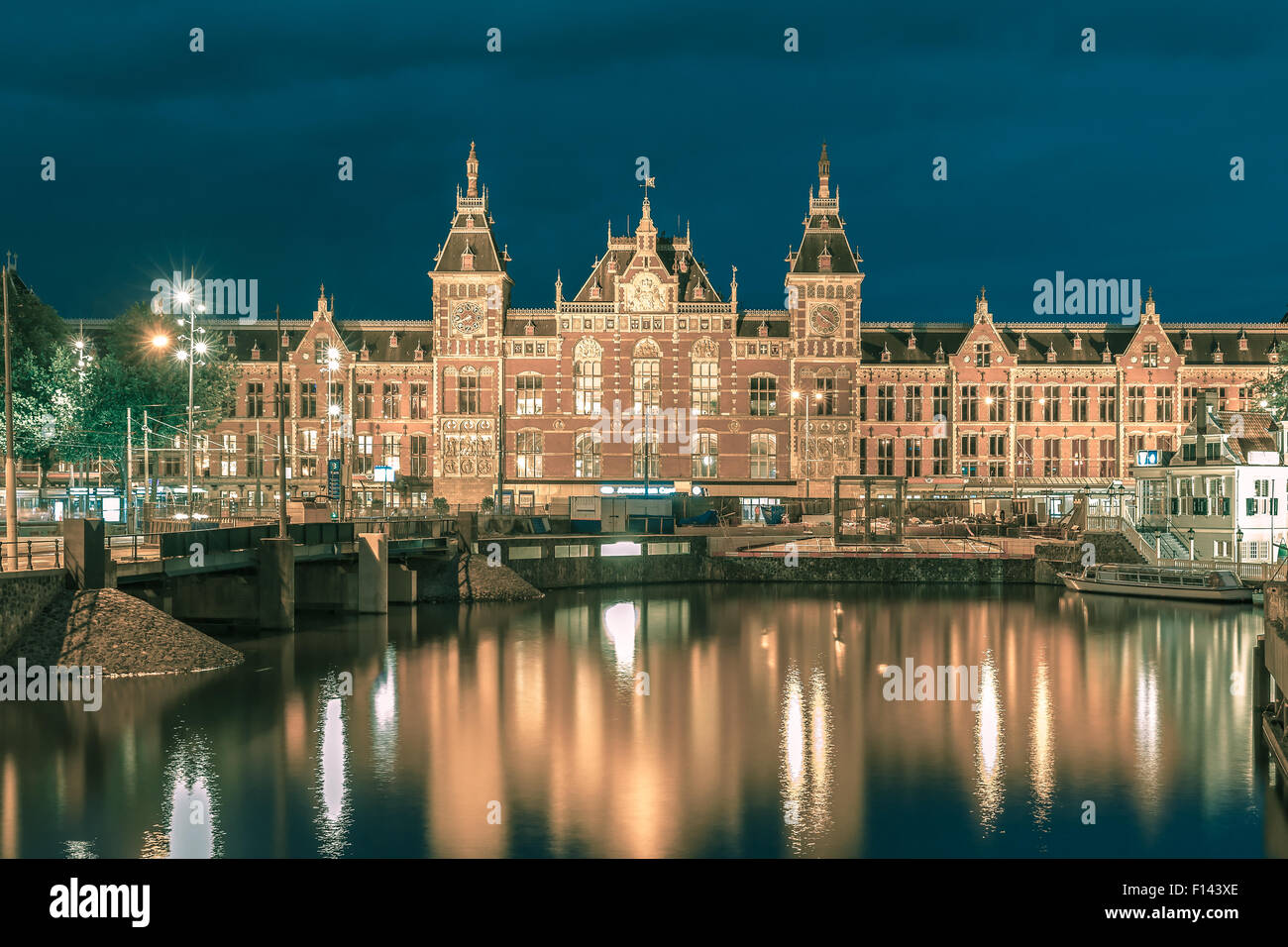 Night Amsterdam canal and Centraal Station Stock Photo