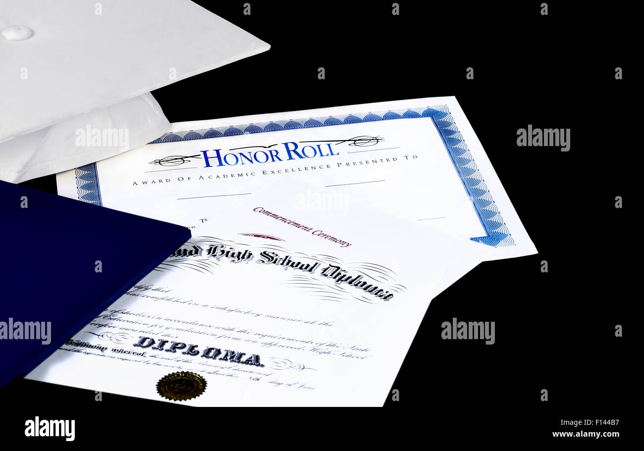 Honor Roll award with high school diploma and commencement ceremony program with graduation cap Stock Photo