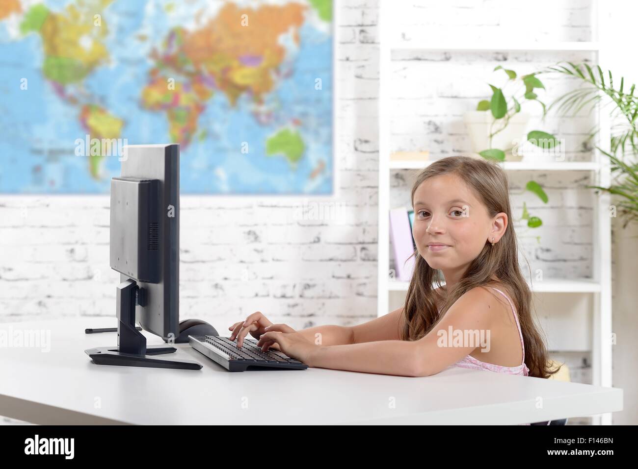 a schoolgirl working on a computer in the classroom Stock Photo - Alamy