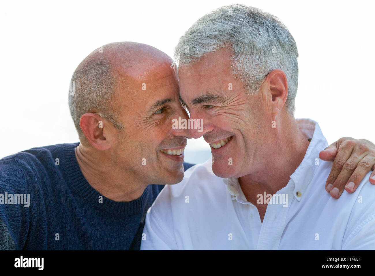 Senior gay male couple, smiling and affectionate, in love and on vacation Stock Photo