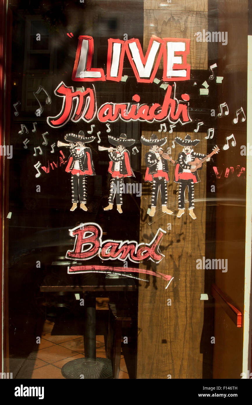 Painted window sign on Valencia Street in The Mission in San Francisco, California. 'Live Mariachi Band' Stock Photo