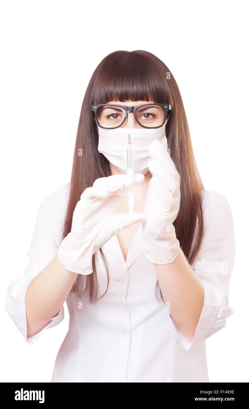 Beautiful young doctor in medical robe holding syringe Stock Photo