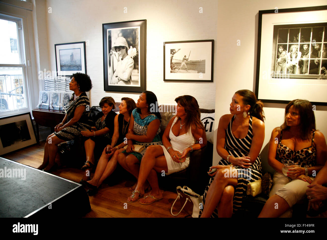 New York, USA. 26th August, 2015. Audience listens to a conversation between Tennis legend Billie Jean King and british photographic legend Terry O'Neil during a reception at New York's Morrison Hotel Gallery in Soho on August 27th, 2015.   The event sponsored by Citibank was to promote a show and book by O'Neil who photographed King and other celebrities extensively in the 1970's and 80's.  Images of celebrities photographed by O'Neil, including Audrey Hepburn, Elton John and The Who, hang above the audience, Credit:  Adam Stoltman/Alamy Live News Stock Photo