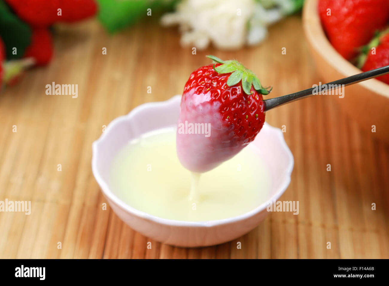 Strawberries with condensed milk Stock Photo