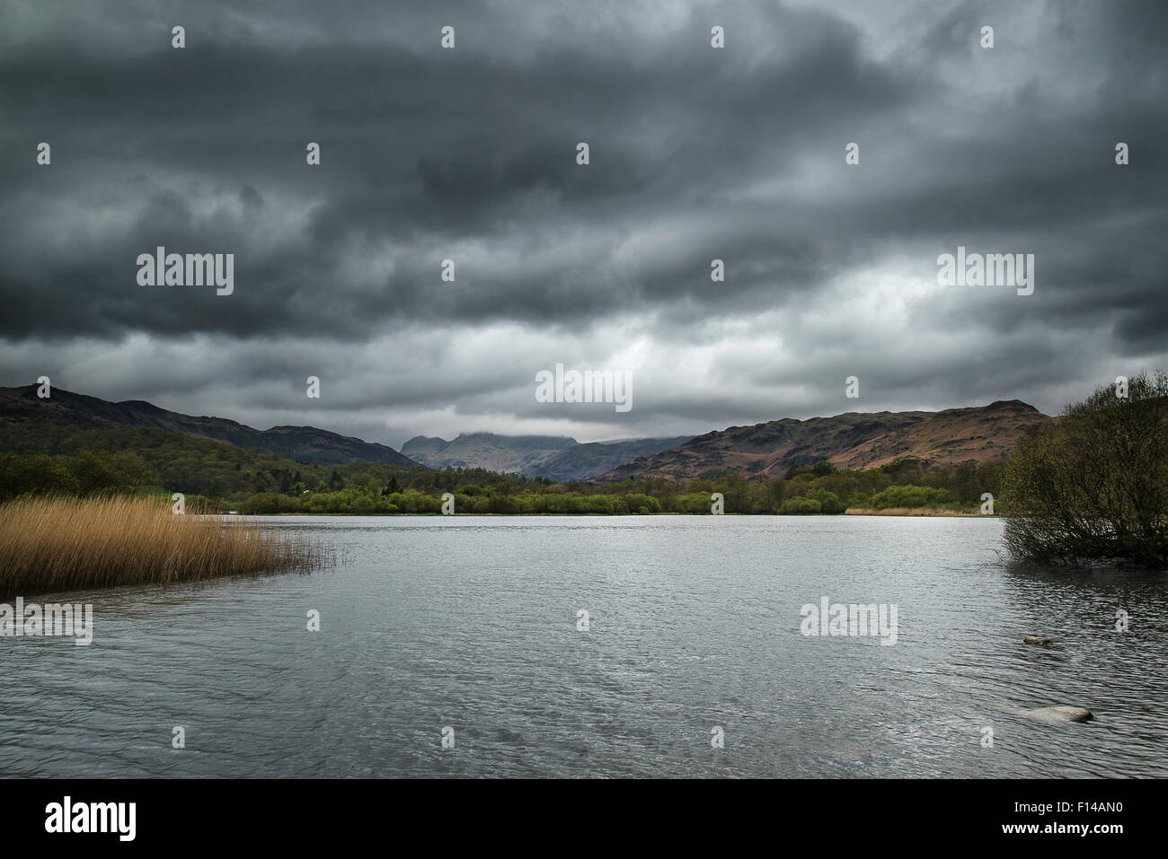 Stormy dramatic sky over Lake District landscape in England Stock Photo