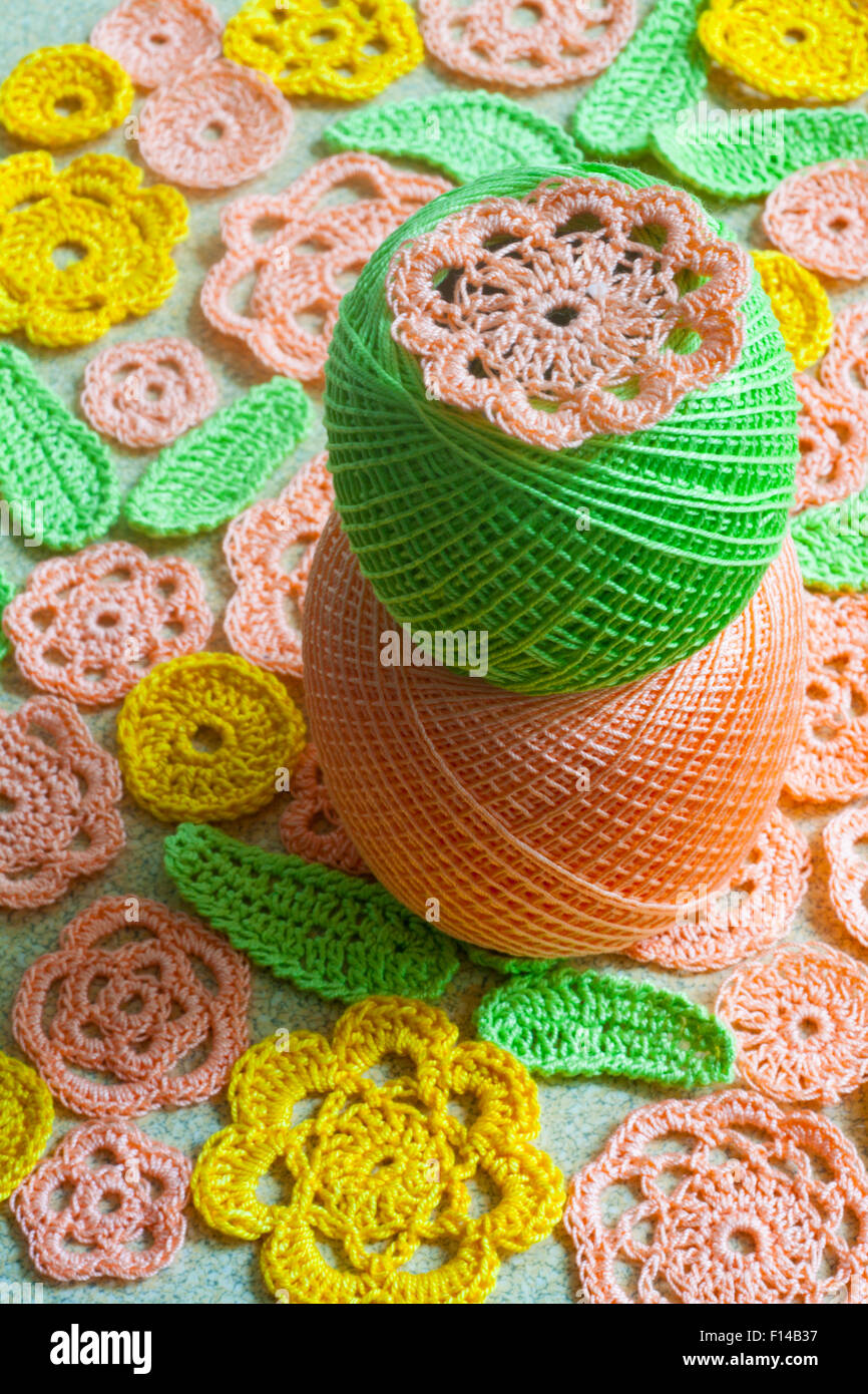crocheted flowers in irish lace style and balls of yarn Stock Photo - Alamy